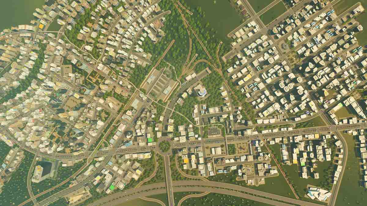 O vedere de ansamblu de la înălțime a structurii unui oraș dens, cu drumuri și clădiri rezidențiale și comerciale în Cities: Skylines